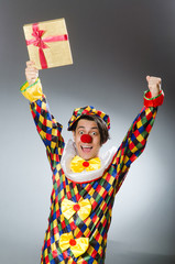 Clown with giftbox in funny concept