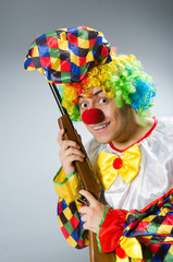 Clown with rifle isolated on white