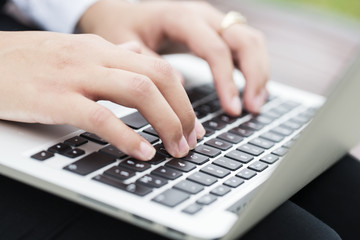 Woman fingers typing on keyboard