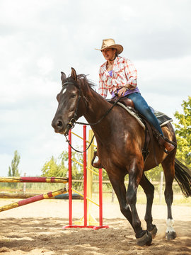 Western cowgirl woman training riding horse. Sport
