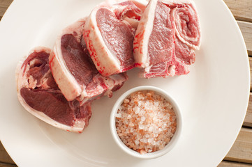 Fresh Lamb Meat Chops on Plate with Salt
