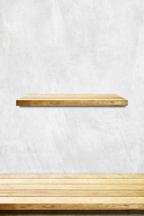 Empty wooden table and shelf over cement wall background
