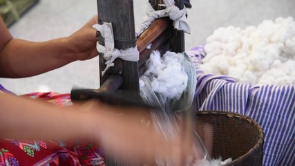 Spinning wooden wheel prepare cotton fibers in to the basket.