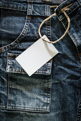 White card on wrinkled jeans