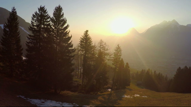 Fantastic golden sun rays shining in mountains, magic atmosphere, little village