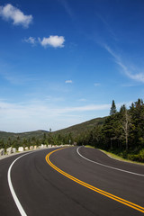 Winding road in Adirondack mountains, upstate New York, USA. Transportation, travel, explore, vacation, summer, destination, driving and nature concept