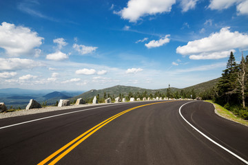 Winding road in Adirondack mountains, upstate New York, USA. Transportation, travel, explore,...