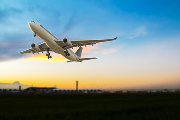 Fototapeta na wymiar Commercial airplane take off at sunset