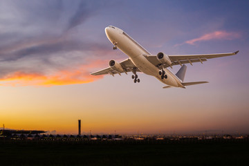 Fototapeta premium Commercial airplane take off at sunset