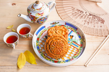 Moon cake and tea set on wooden table, Chinese mid-autumn food festival