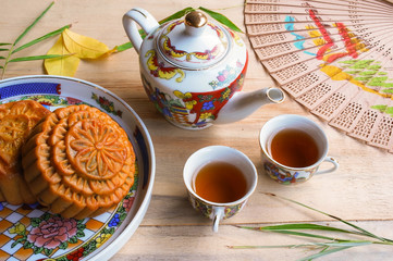 Moon cake and tea set on wooden table, Chinese mid-autumn food festival