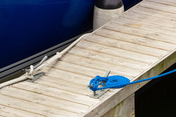 Yachting, blue rope and mooring bollard