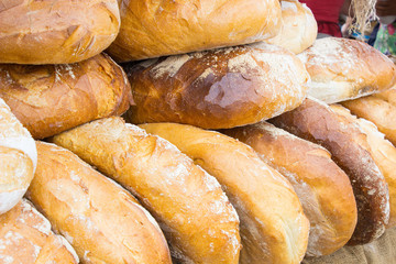 Freshly baked traditional loaves of rye bread on stall