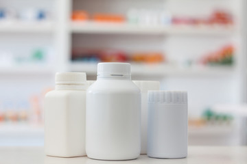 many medicine bottle with blur shelves of drug in the pharmacy d