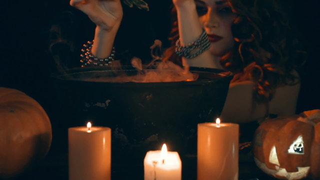 Horned she devil preparing magic potion by candlelight 