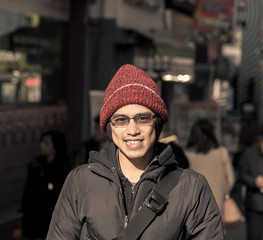 Asian male in winter chilling out in city instagram tone