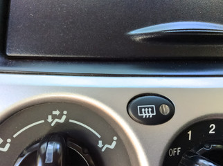 button for defroster on automotive glass