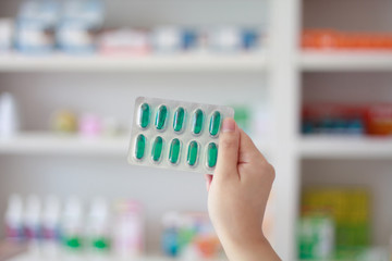 Close up of female doctor hands holding pills