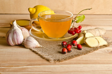 Cup of tea,slices of ginger,honey,rosehip berries and viburnum o