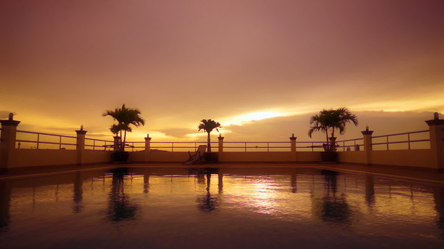 Golden sunset reflected in rippled swimming pool water. FullHD 1080p.