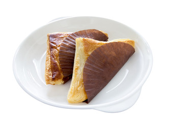 Pie triangular shape on white dish, isolated on white background