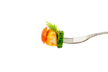 a piece of fried meat with vegetables closeup macro on a fork isolated on a white background