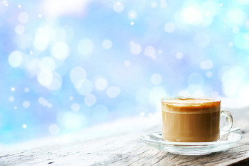 Cup of hot coffee on wooden table