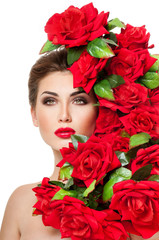 Beautiful woman face surrounded by red roses. Perfect skin. Prof