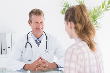 Happy doctor listening his patient 