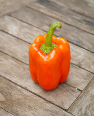 Red sweet pepper on a wooden table