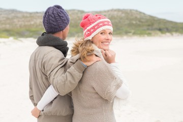 Happy couple embracing by the shore