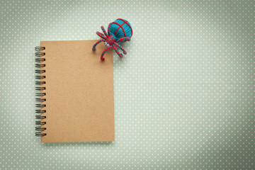 Vintage style background of brown notebook with thread spider 