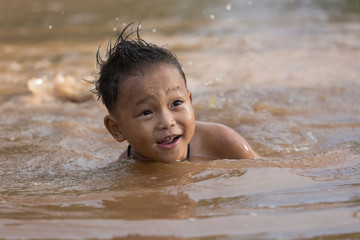 The boy bathes in water.