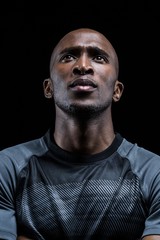Fototapeta premium Thoughtful athlete against black background