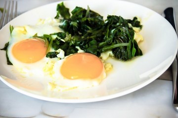 Creamy spinach with fried egg. Healthy breakfast