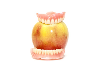 False teeth and an apple