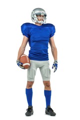 American football player looking away while holding ball