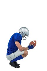 Profile view of American football player in attack stance © WavebreakmediaMicro