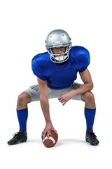 American football player placing ball