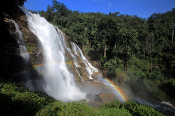 Powerful stream waterfall in rainforest with rainbow, Chiang Mai