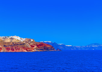Amazing view from the sea, of volcano's caldera and of Oia the most beautiful village of Santorini island in Greece