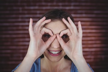 Woman holding hands as binoculars 