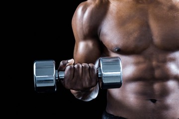 Cropped image of muscular athlete exercising with dumbbell