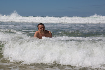 Man having fun at the beach during summertime