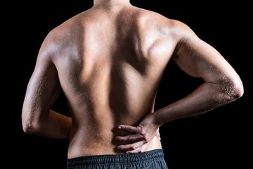 Fototapeta na wymiar Rear view of shirtless man with back pain
