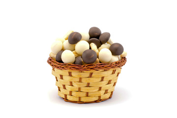 chocolate mushrooms in a basket isolated on a white background