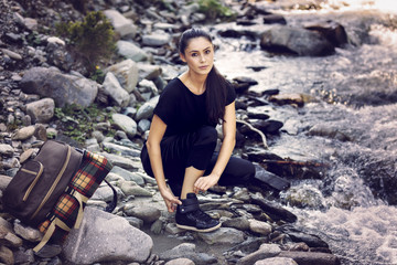 Young Asian woman hiker by the river, outdoors activities
