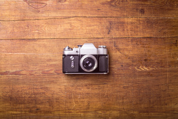 Retro camera on wood table background