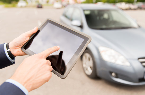 close up of young man with tablet pc and car