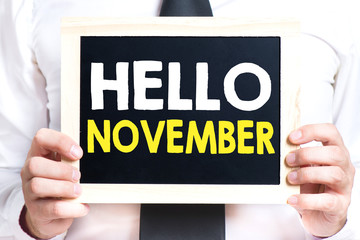 Hands holding blackboard with hello november